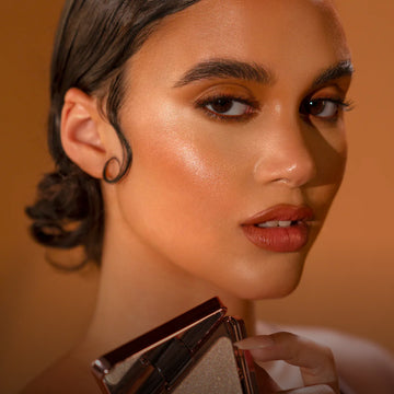 Model holding LYS Beauty face product